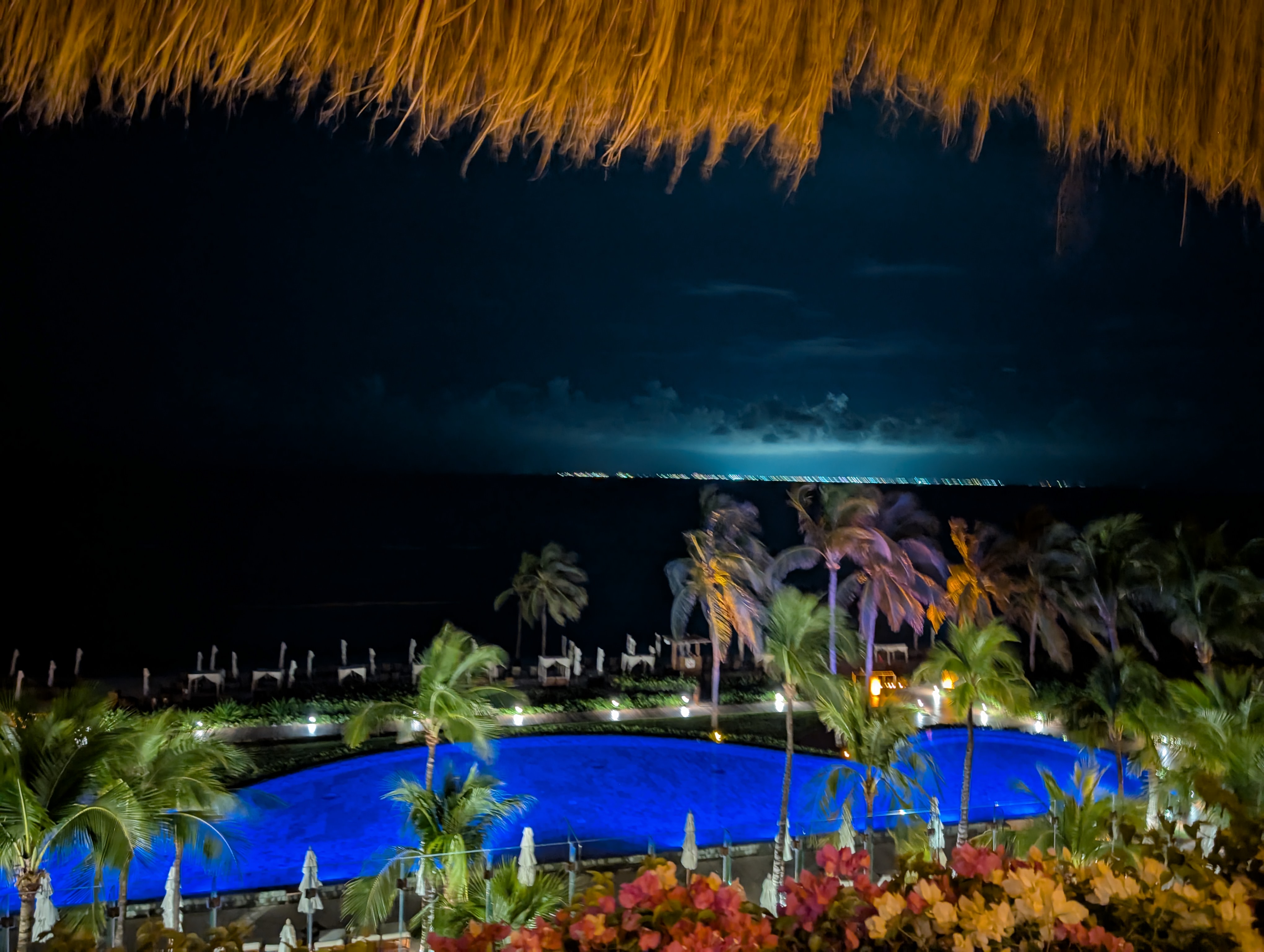 Grand Velas Riviera Maya pools illuminated at night against the Caribbean sky